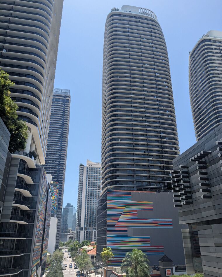 Glass high-rise towers in Brickell, Miami's business district, under a clear sky